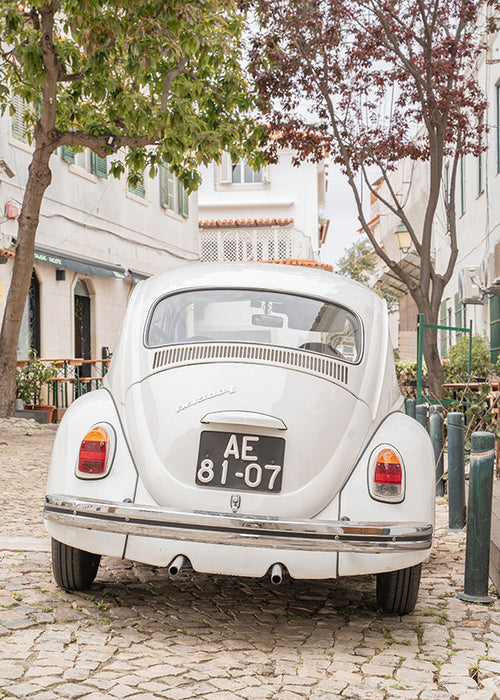 Stadtbild mit klassischem Auto auf Kopfsteinpflaster